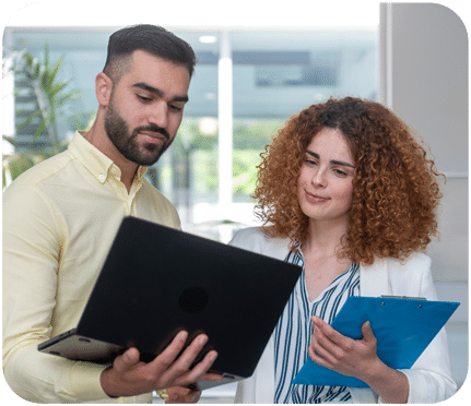 two professionals looking at a computer
