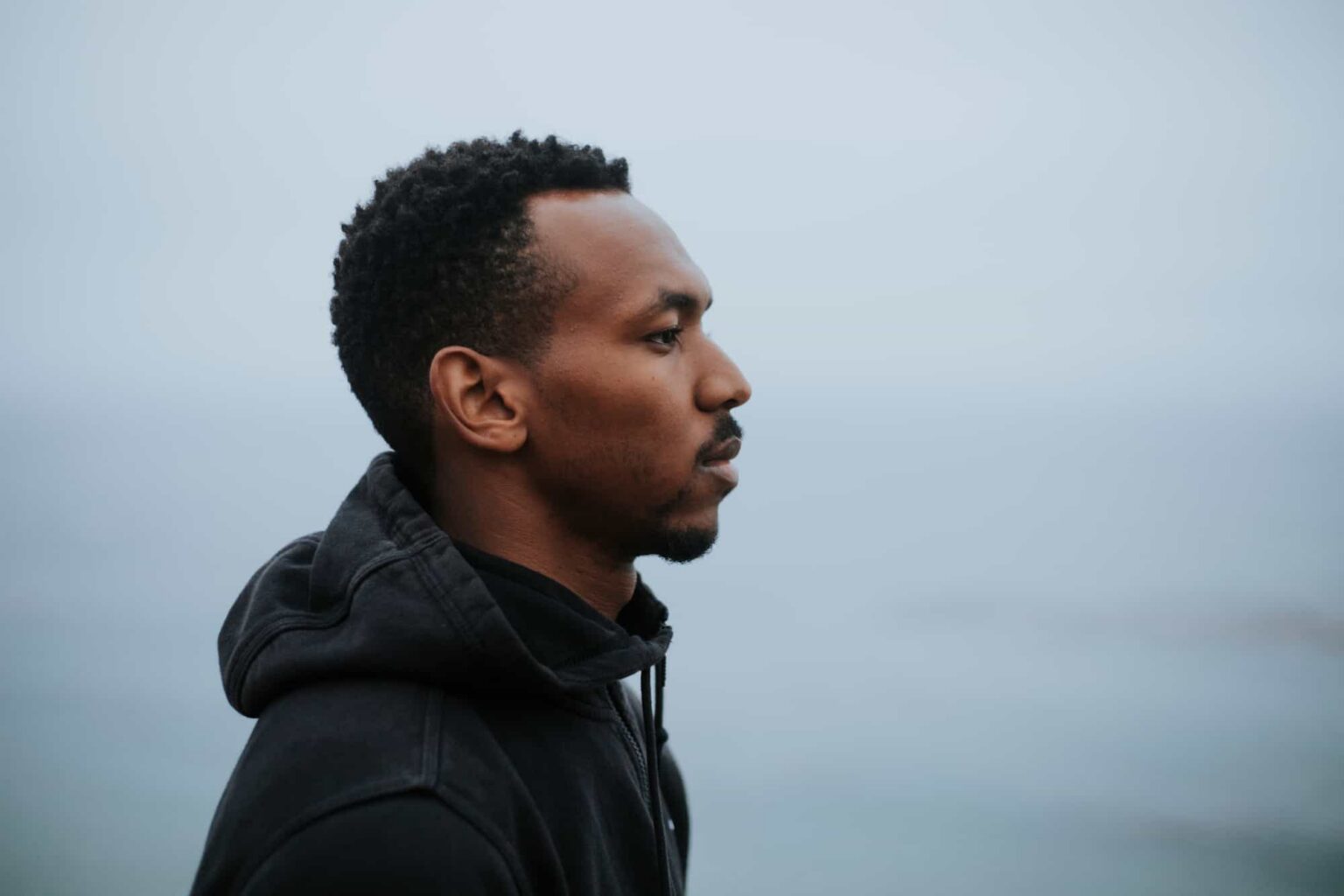 Man gazing thoughtfully at ocean