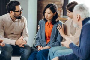 group therapy session discussing emotional trauma