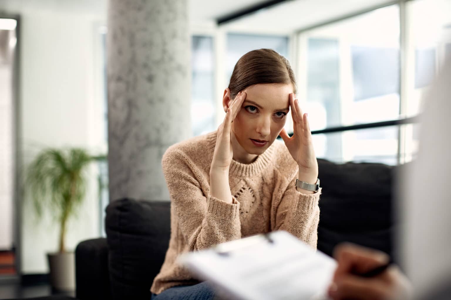 Young woman discussing trauma at doctor's office.